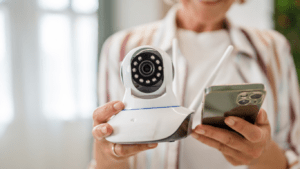 woman holding cctv and cellphone