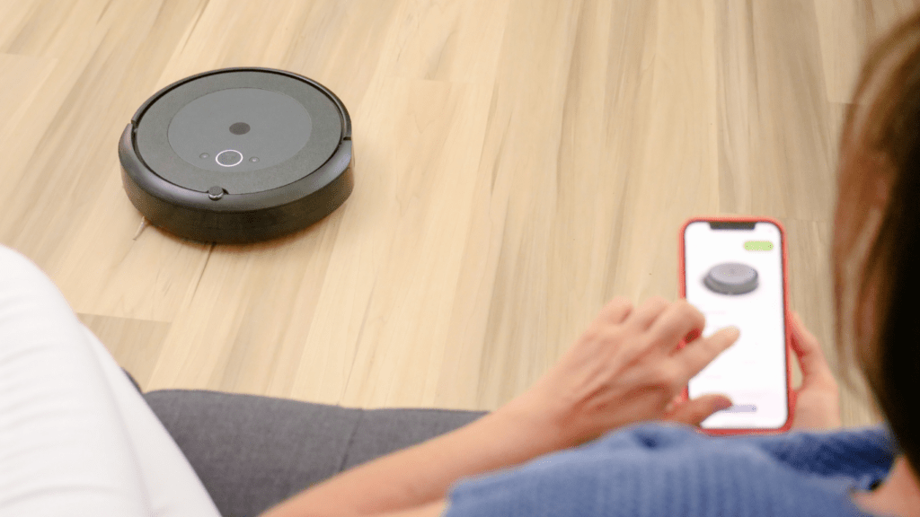 Woman controlling the smart vacuum using smart app